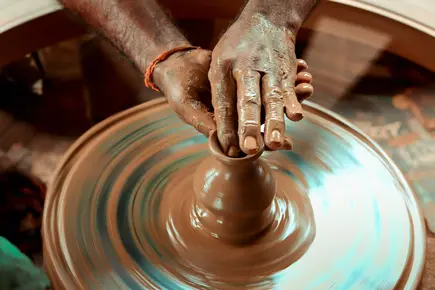 hands making clay item